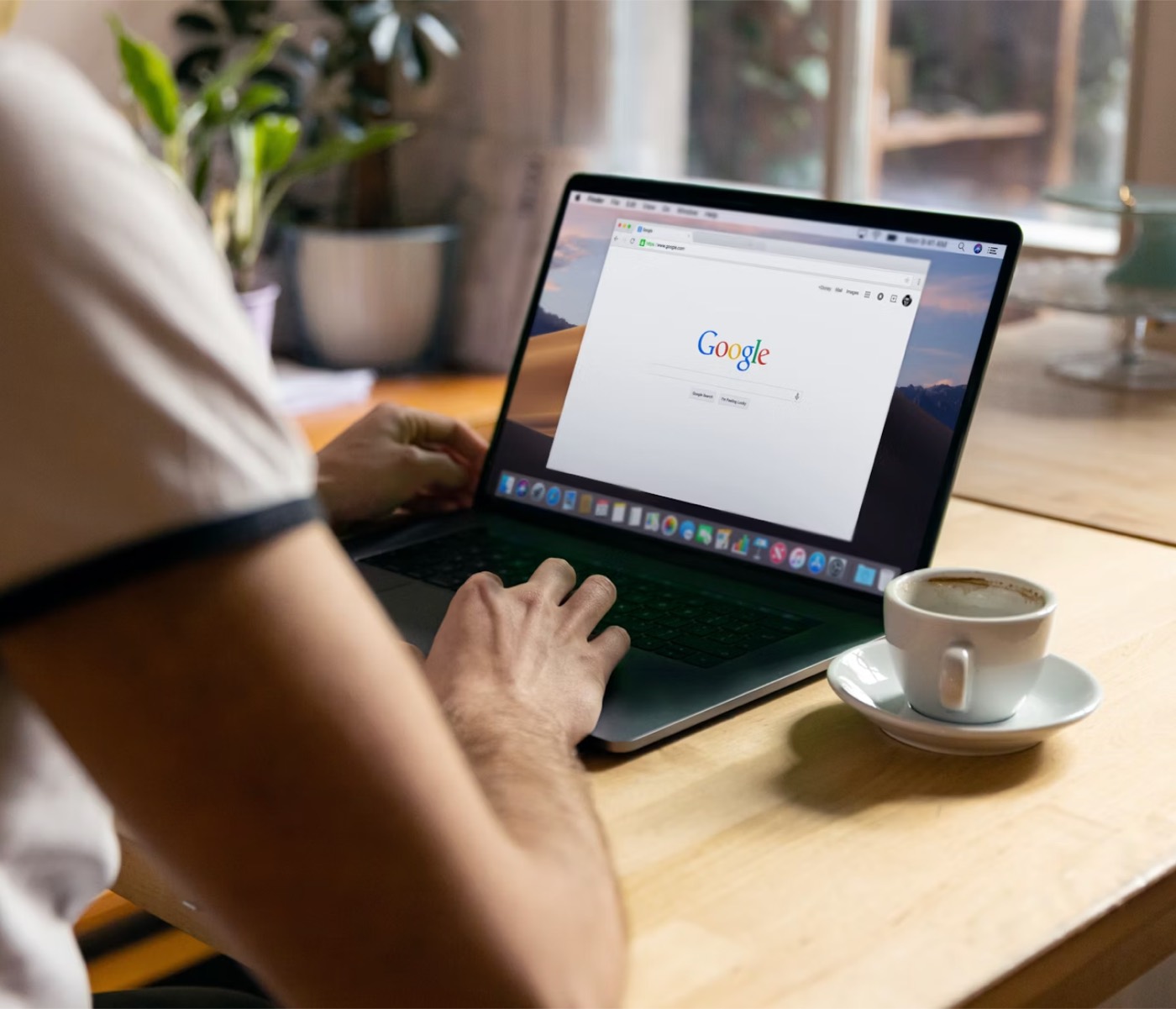 Person searching on Google on a laptop